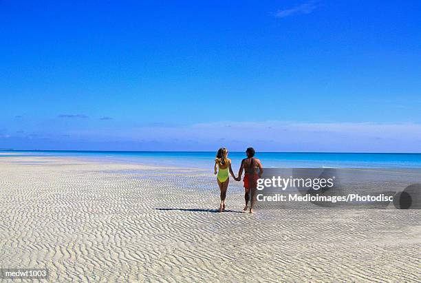 couple alone on beach at lucayan national park, grand bahama island, bahamas - grand bahama stock pictures, royalty-free photos & images