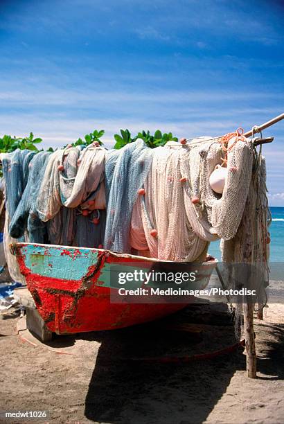 fishing net hanging on boat at anse la raye in st. lucia, caribbean - net fishing stock pictures, royalty-free photos & images
