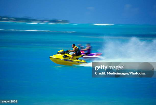 people on wave runners near luquillo beach, puerto rico, selective focus - puerto stock pictures, royalty-free photos & images
