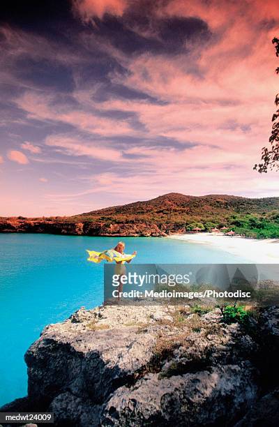 woman wearing a pareu and standing on the cliffs of knip beach, curacao, caribbean - オランダ領リーワード諸島 ストックフォトと画像