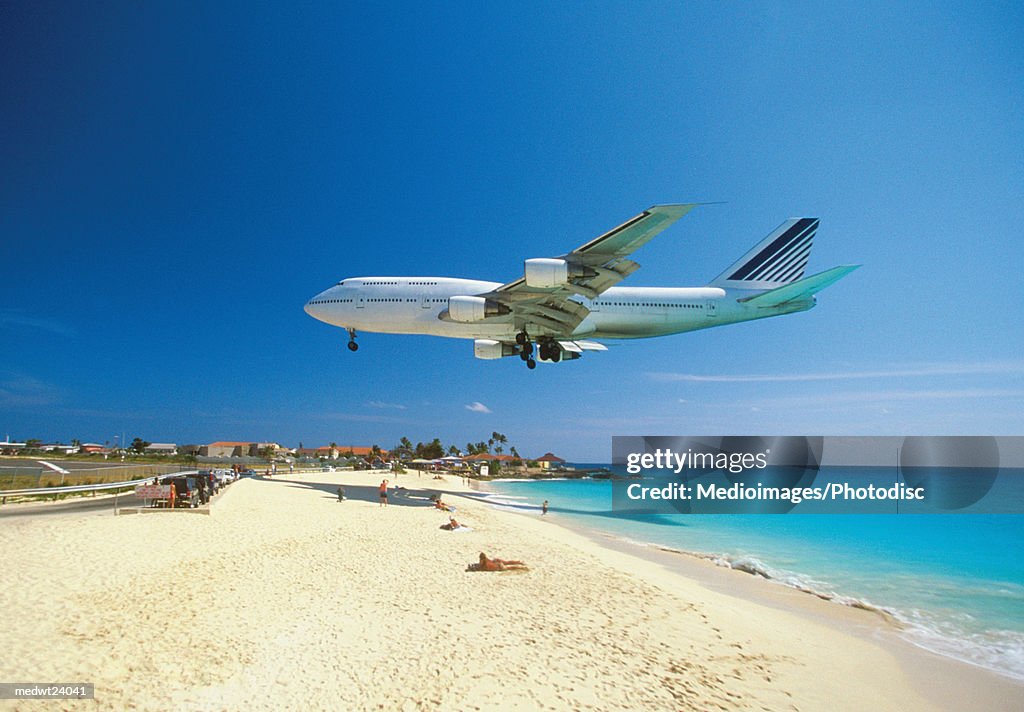 Plane coming in for landing on Maho Bay Beach, Saint Martin, Caribbean