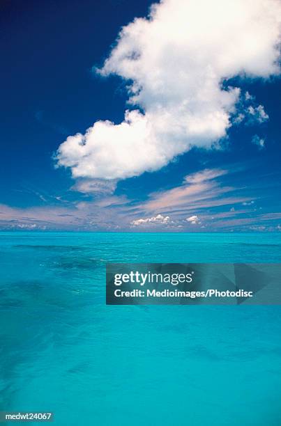 the blue waters of the caribbean off bermuda under blue skies with a few clouds - atlantic islands stock-fotos und bilder