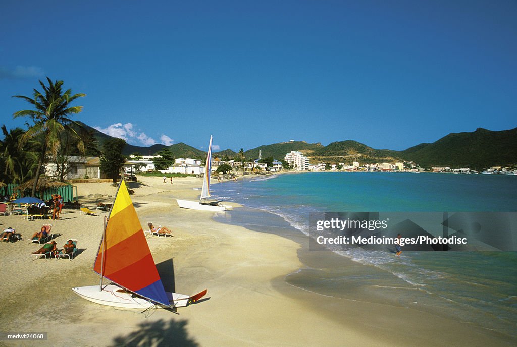 Sailboat and people on Great Bay Beach on Saint Martin, Caribbean