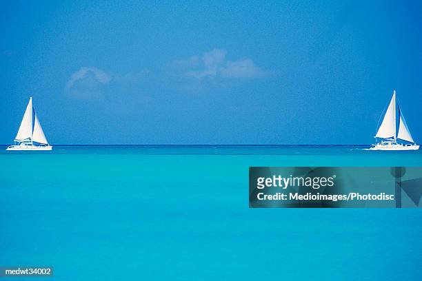 caribbean, turks and caicos islands, providenciales, grace bay beach, sailboats in ocean - bay islands stock pictures, royalty-free photos & images