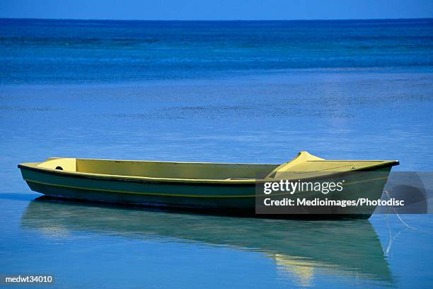 caribbean, jamaica, fishing boat floating on water - greater antilles foto e immagini stock