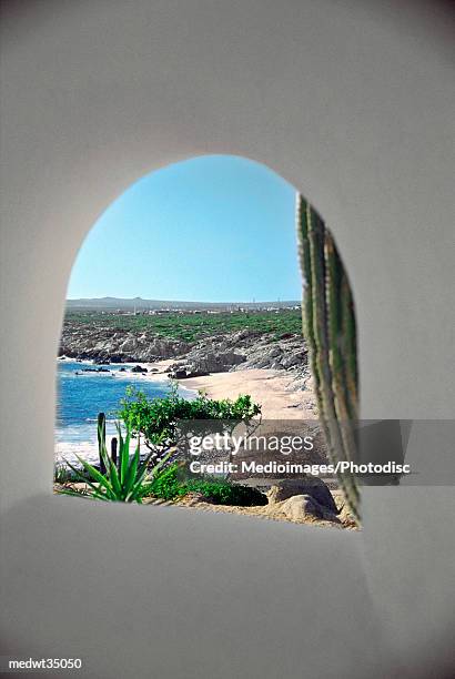 mexico, baja california, cabo san lucas, view of a beach through a window - cabo stock pictures, royalty-free photos & images