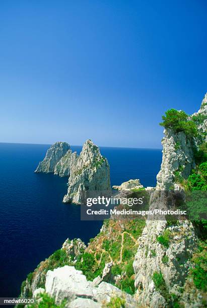 view of capri, italy from monte solaro on faraglioni rocks - golfo di napoli stock-fotos und bilder