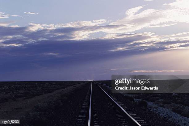 railroad tracks disappear into the australian outback region. - region stock pictures, royalty-free photos & images