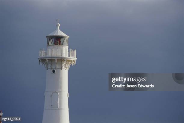 lighthouse against a dark sky. - nautical structure stock pictures, royalty-free photos & images