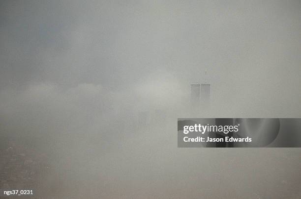 new york, new york. new york city with world trade center through a storm front. - new york city center stock-fotos und bilder