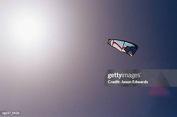 point henry, victoria, australia. a kite surfing sail in a clear blue sky with sunlight. - henry stockfoto's en -beelden