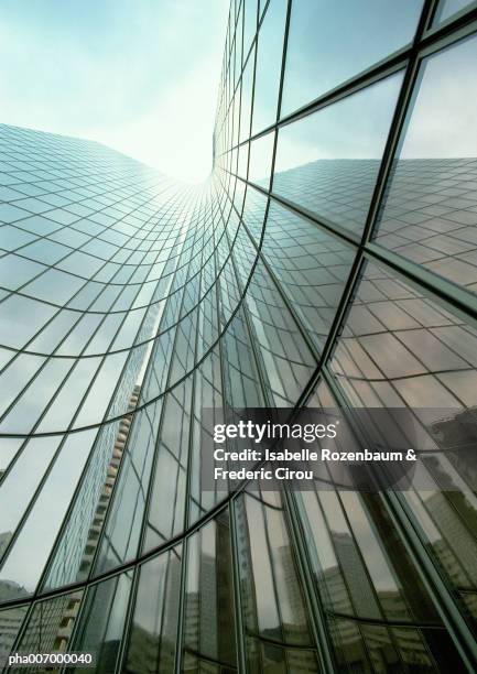 skyscraper with glass facade, reflection, low angle view - reflection foto e immagini stock