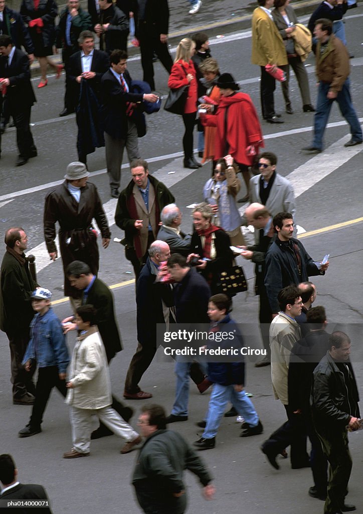 Crowd walking in street, view from above, blurred.