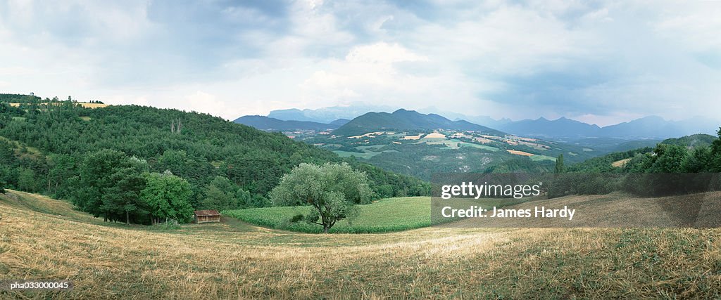 Hillside, mountains in background, panoramic view