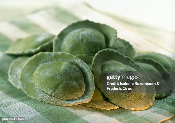 fresh spinach ravioli, on green and white checked tablecloth, close-up - ravioli foto e immagini stock