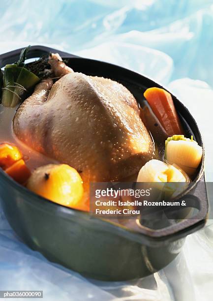 whole chicken in deep casserole dish with vegetables, close-up - bouillon stock pictures, royalty-free photos & images