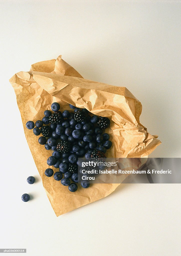 Blueberries and blackberries on brown paper