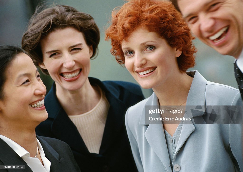 Group of four business people, smiling