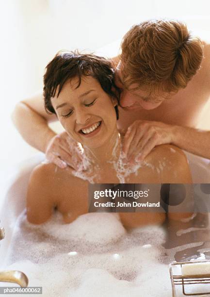 woman taking bath, man massaging her shoulders - girlfriend massage ストックフォトと画像