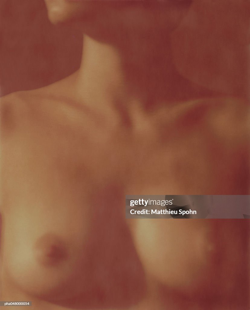 Woman's bare bust, blurred