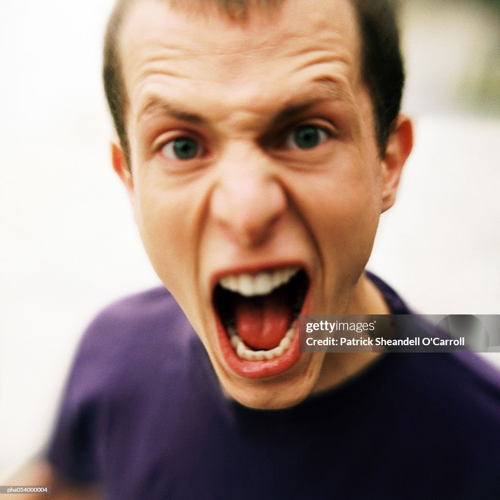 Male teenager shouting, portrait