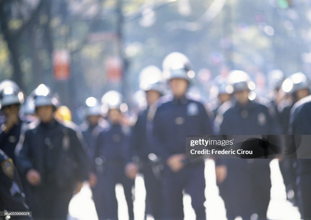 Riot police, blurred