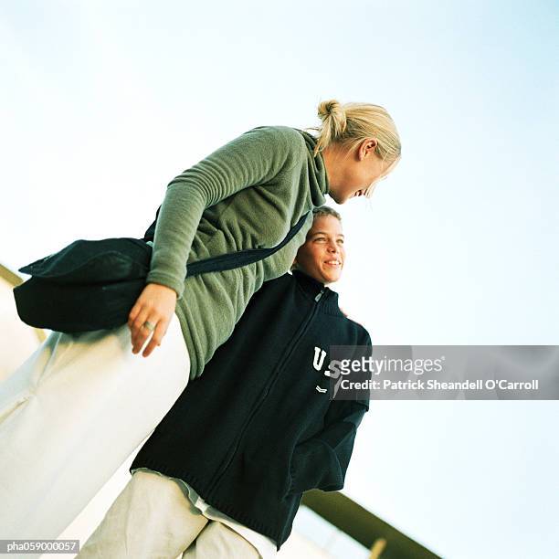 teenage boy and girl embracing, low angle view - joined at hip stock pictures, royalty-free photos & images
