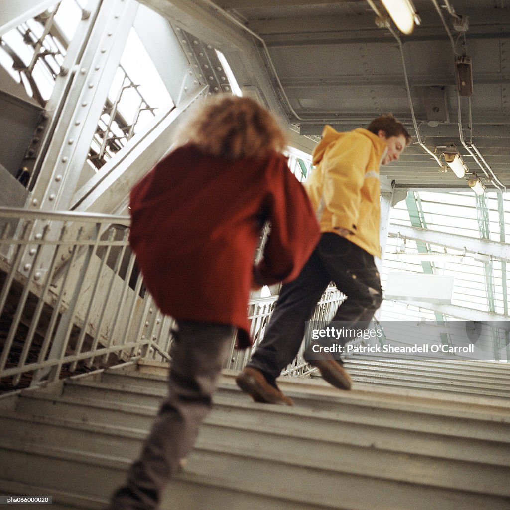 Young people walking up stairs in elevated subway station