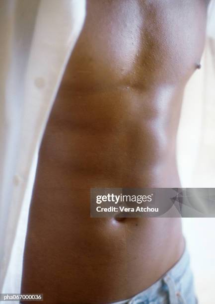 man standing with shirt open, close up of torso - africain stock pictures, royalty-free photos & images