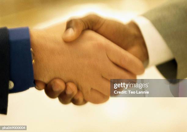 blurred close-up of handshake. - africain stockfoto's en -beelden