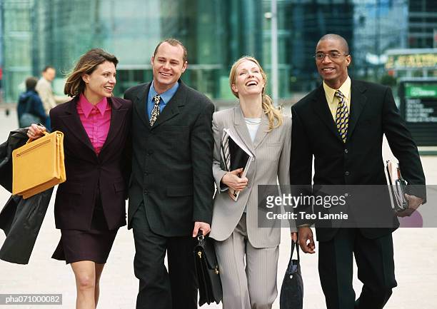 group of business people walking together outside, three quarter length, front view - three quarter length stock-fotos und bilder