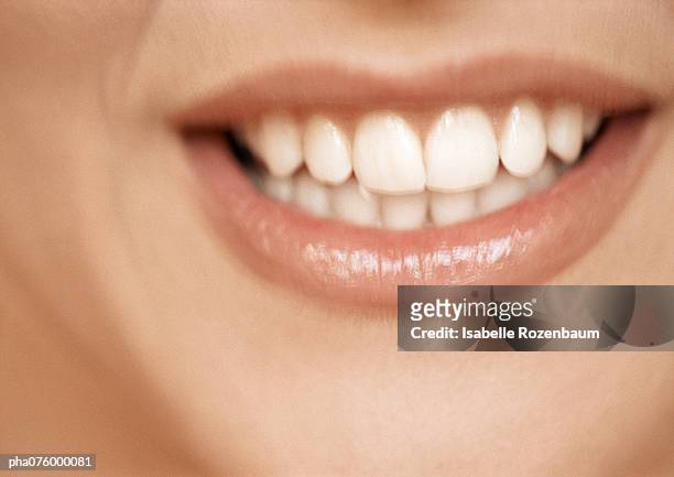 lower section of woman's face, toothy smile, extreme close-up - smile close up stock-fotos und bilder