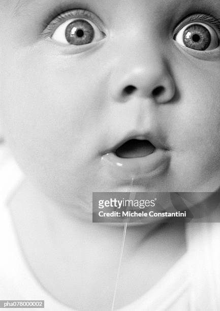 baby with mouth open, drooling, looking out of frame, extreme close-up, b&w. - out of frame stock pictures, royalty-free photos & images