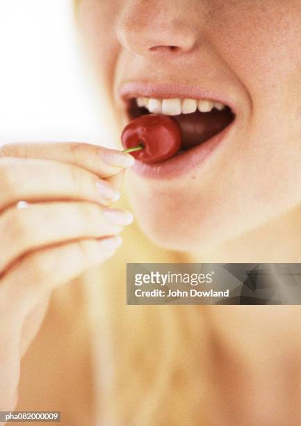 woman eating cherry, close up. - chewing with mouth open stock pictures, royalty-free photos & images