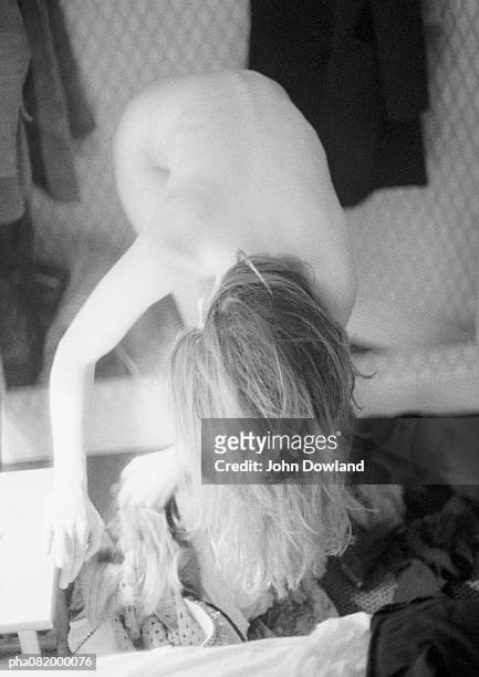 nude woman bending over at waist, looking through bag, full length, b&w. - backed stock pictures, royalty-free photos & images