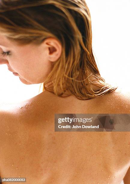 woman with bare back, head turned to side, rear view, close-up - bare back stock-fotos und bilder