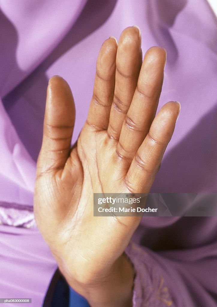 Woman's palm held up in prayer, close-up