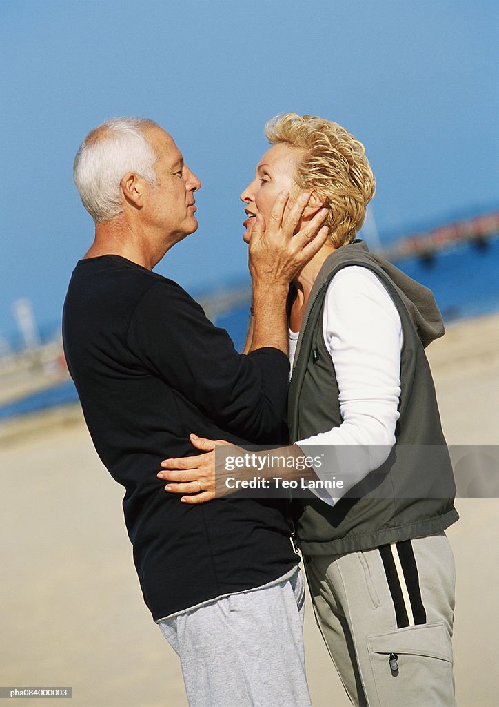 Senior couple embracing on the beach.