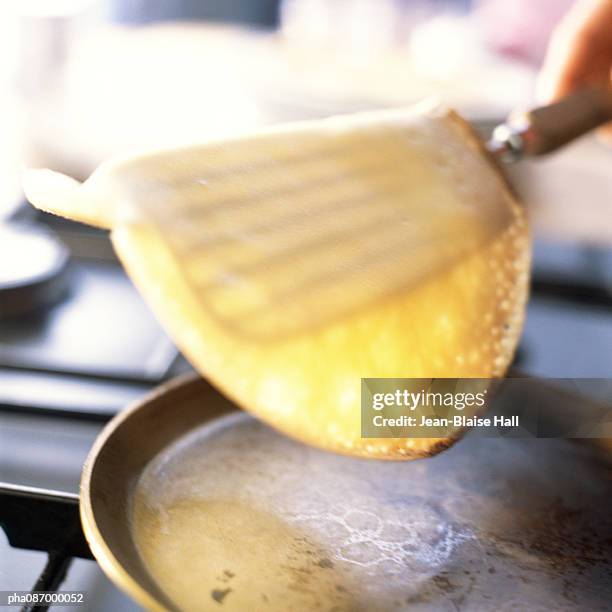 close-up of crepe being flipped. - crepe stock pictures, royalty-free photos & images