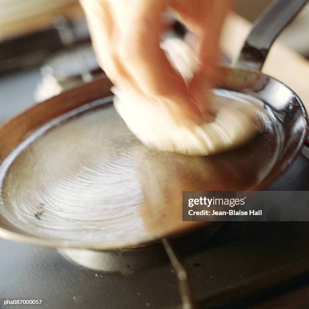 close-up of a pan being oiled, blurry. - pan imagens e fotografias de stock