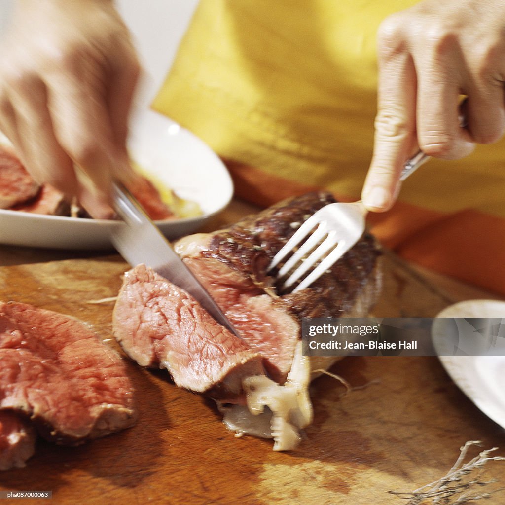 Close-up of cooked meat being cut.