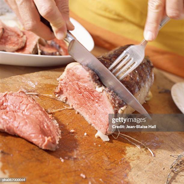 close-up of cooked meat being cut. - ローストビーフ ストックフォトと画像