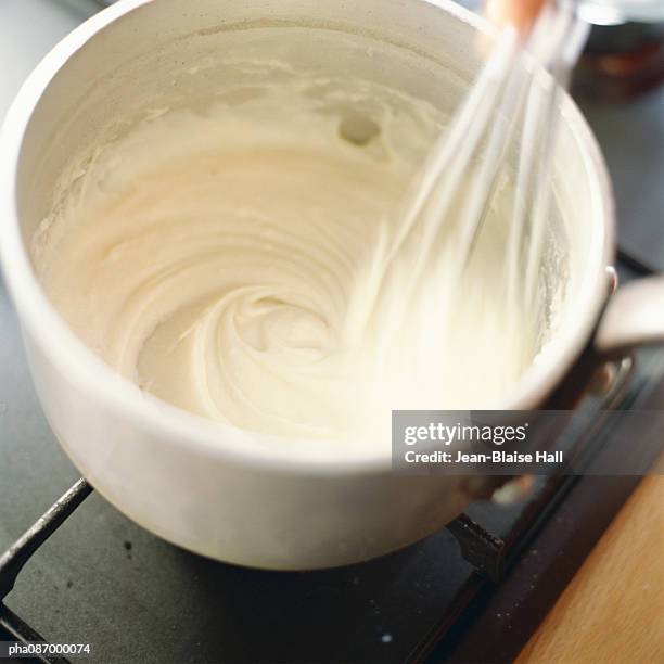 close-up of food being mixed in pot. - cream sauce stock pictures, royalty-free photos & images
