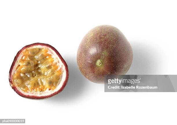 a passion fruit and a half, white background - maracuja stock-fotos und bilder
