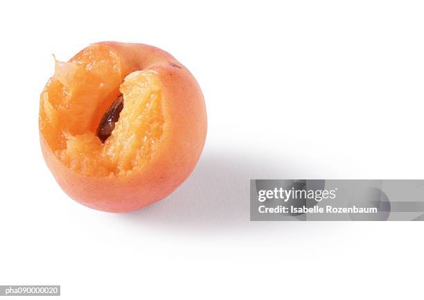 a bitten apricot, white background - croquant photos et images de collection