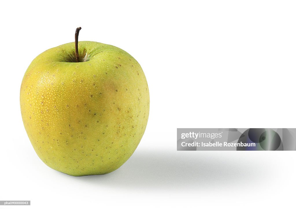 Golden yellow apple, white background
