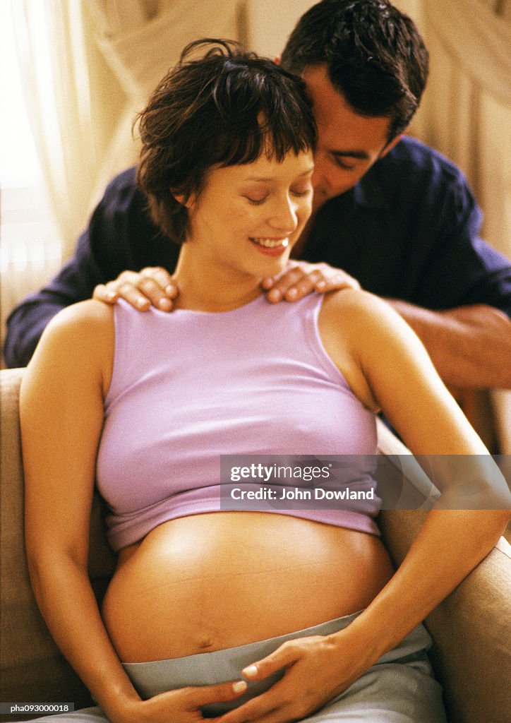 Man massaging pregnant woman