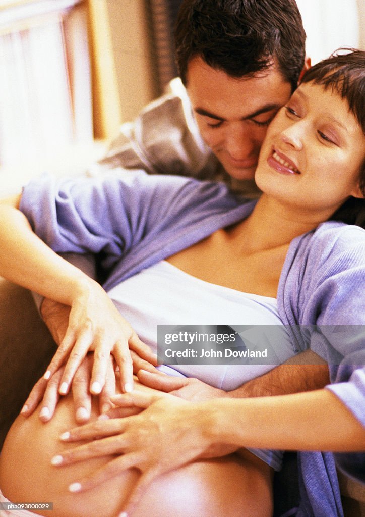 Man touching pregnant woman's stomach
