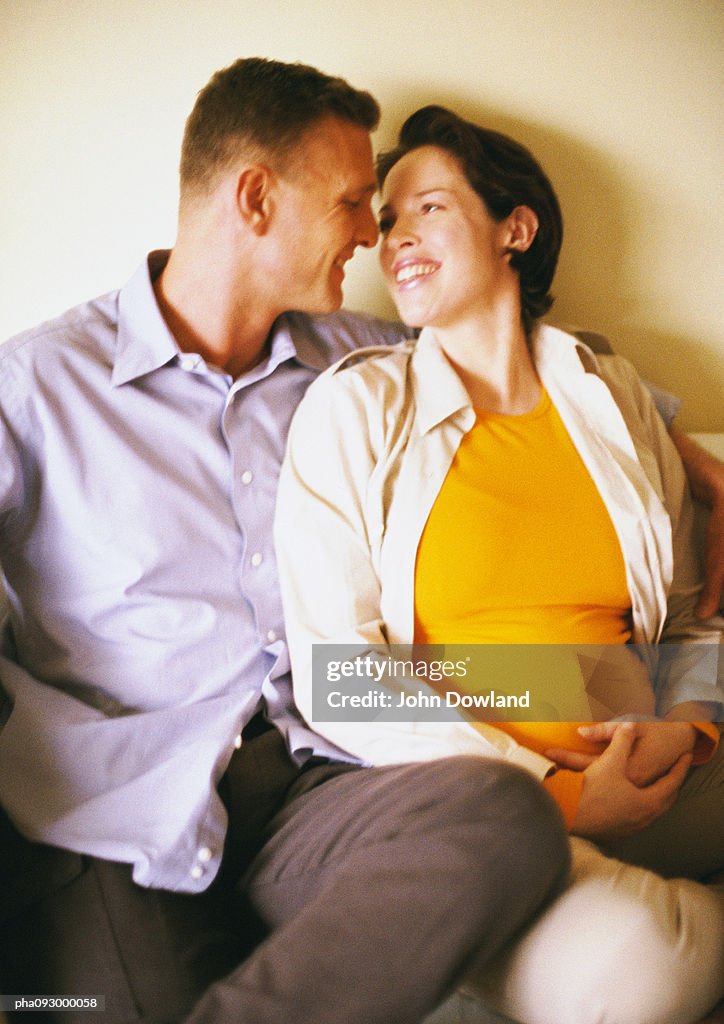 Man and pregnant woman smiling