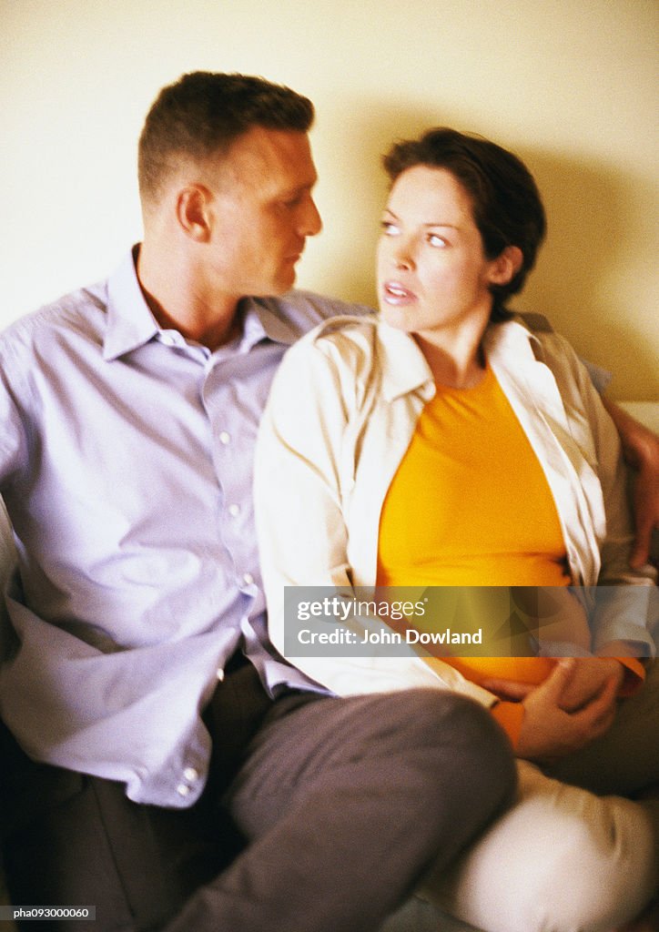 Man and pregnant woman sitting